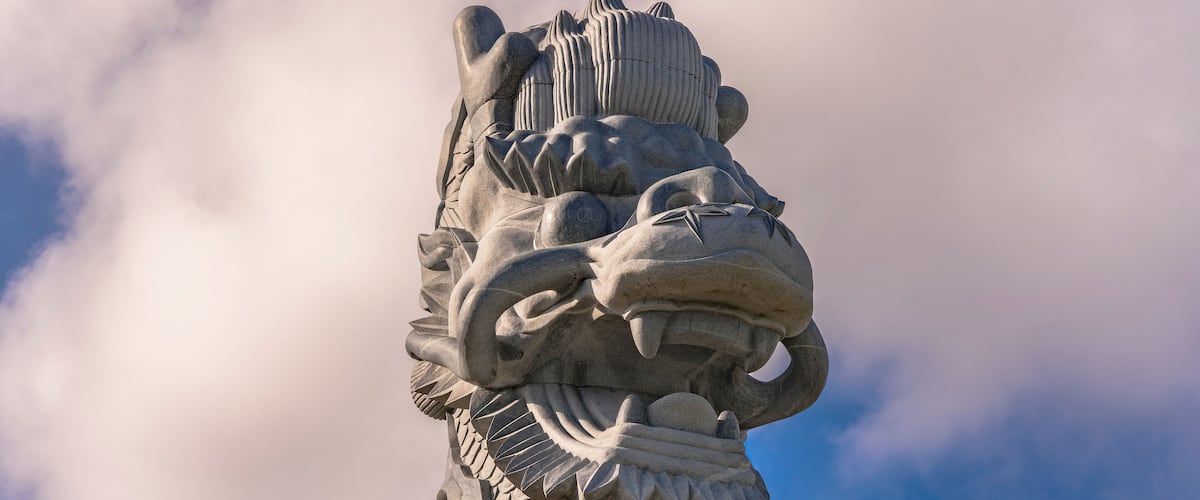 Close-up on the stone dragon head of the pillars that greet cruise ship visitors close to the Naha Port Cruise Terminal dock, symbol of sister cities Naha and Fuzhou in China.