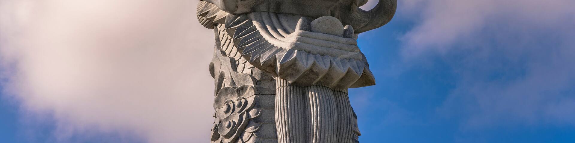 Close-up on the stone dragon head of the pillars that greet cruise ship visitors close to the Naha Port Cruise Terminal dock, symbol of sister cities Naha and Fuzhou in China.
