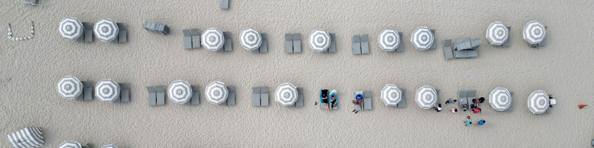 Aerial top view of sand beach with turquoise water. Luxury resort. Paradise beach. Summer vacation. Beach vacation at sea in summer. Sea relax under beach umbrella. Travel to sea. Seaside relaxation