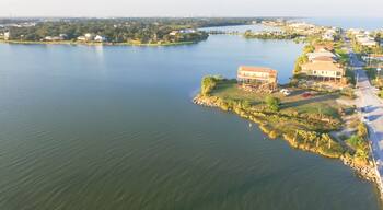 Panorama aerial view of Seabrook city near Texas Gulf Coast and Clear Lake. Waterfront harbor town with pier. Wooden vacation house under construction. Real estate and beach travel background