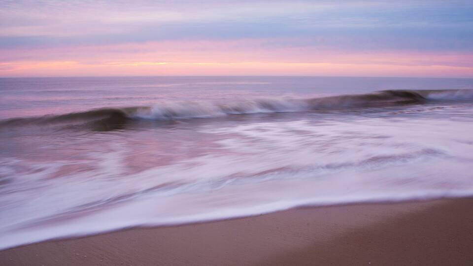 Crashing wave at dawn in Cape Henlopen State Park, Delaware, USA.