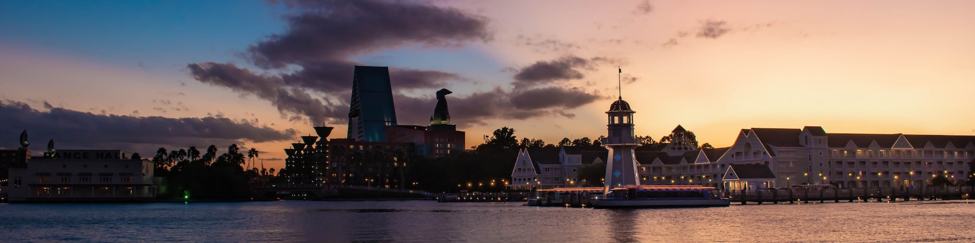 Orlando, Florida. October 11, 2019. Colorful hotel, lighthouse and villas on colorful sunset background at Lake Buena Vista 51.