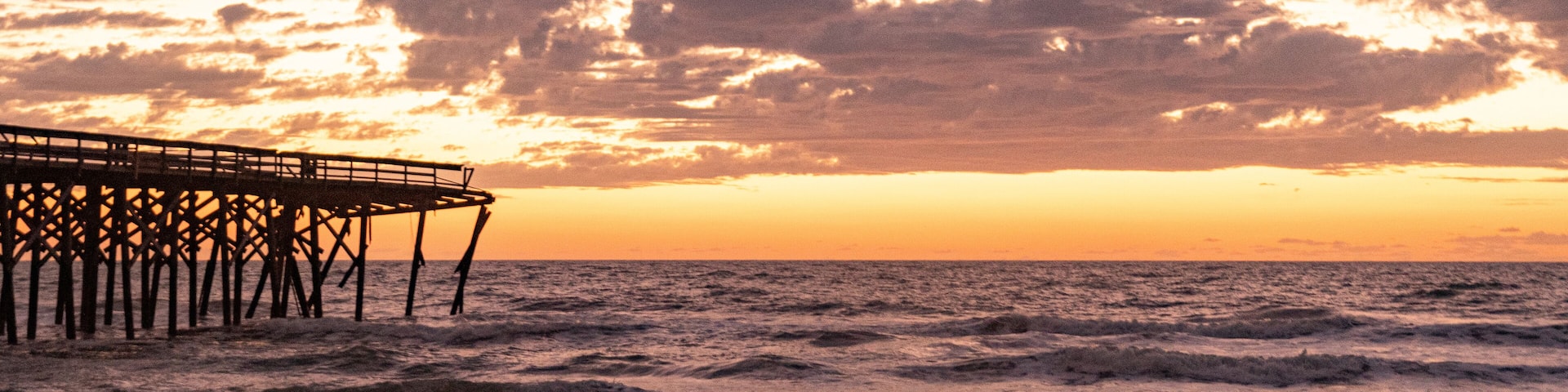 Sunrise over the Pawley's Island fishing Pier one week after half the pier was washed out to sea by Hurricane Ian