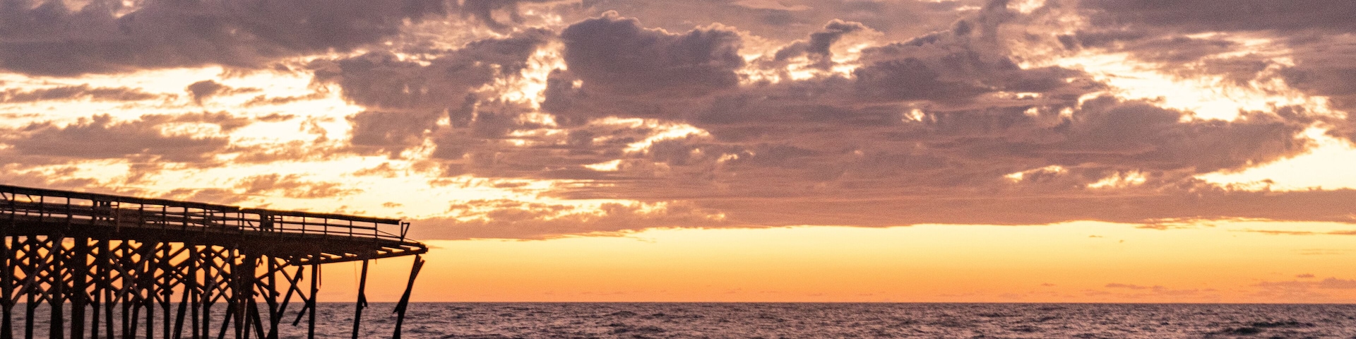 Sunrise over the Pawley's Island fishing Pier one week after half the pier was washed out to sea by Hurricane Ian