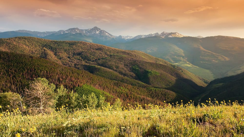Beautiful sunset panoramic view of Colorado Rocky Mountain peaks from the Summit of Vail Colorado's Eagle County.