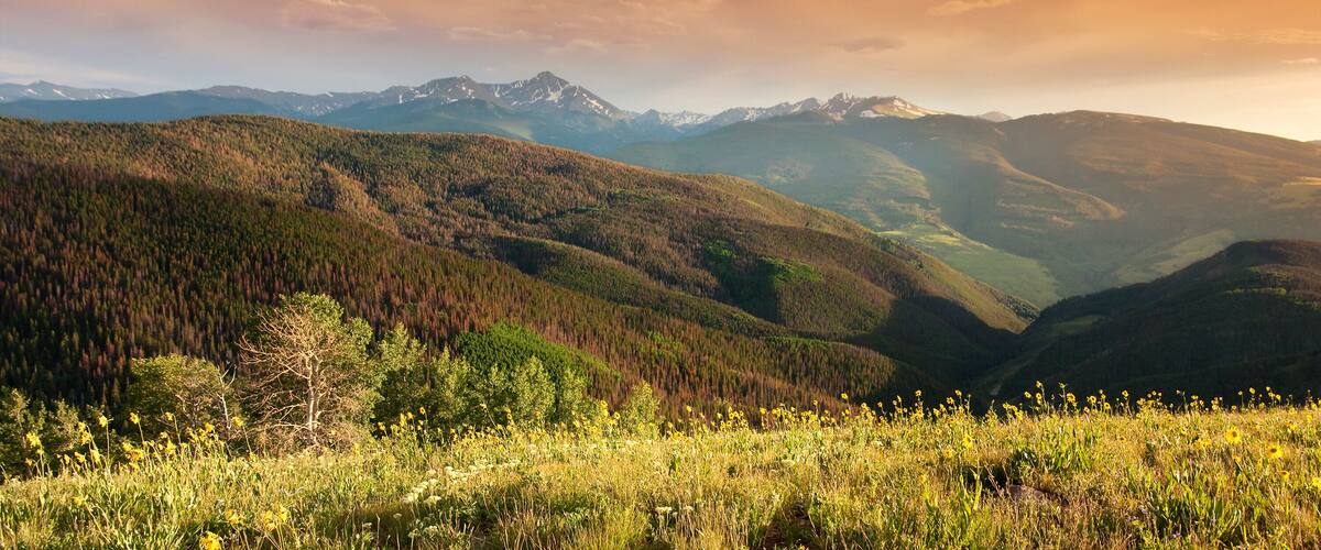 Beautiful sunset panoramic view of Colorado Rocky Mountain peaks from the Summit of Vail Colorado's Eagle County.