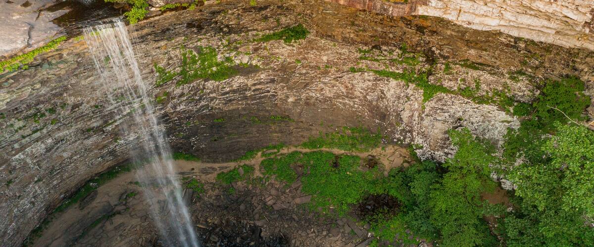 Water flowing over the cliff edge at Ozone falls in Tennessee as the water flows into the pool below