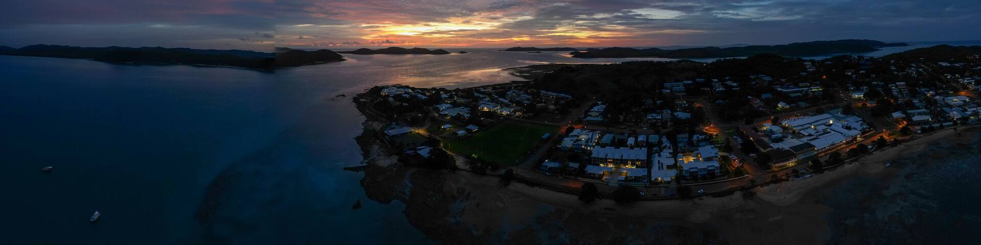 Aerial sunset panorama showing the beach and clear water of Torres Strait