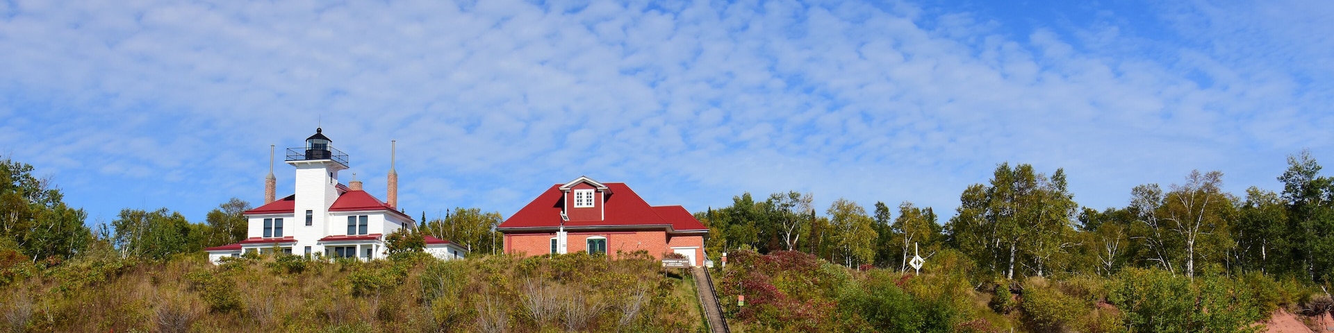 the wooden raspberry island light station, boathouse, dock, and tramway, on the apostle island of raspberry island in lake superior off the wisconsin coast on a sunny fall day