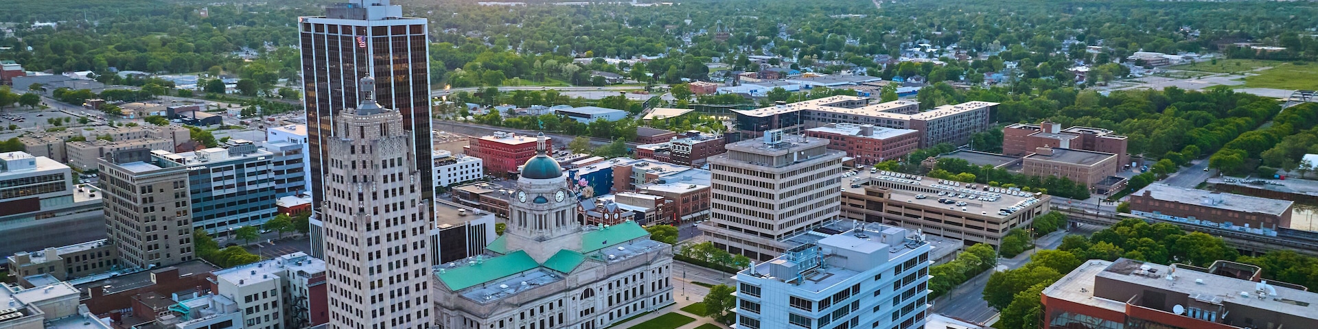 Aerial orange sunrise over downtown Fort Wayne main skyscrapers and Allen County Courthouse