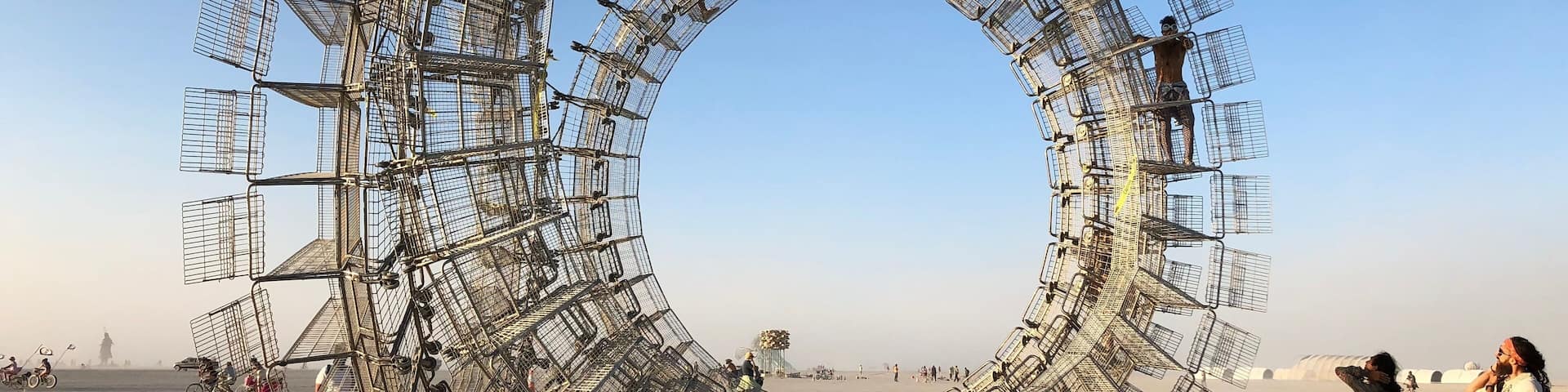 Where can you climb a giant hoop made of shopping carts? Burning Man Arts Festival! Think about going next year. Art: “Perpetual Consumption” by Clayton Blakeart.