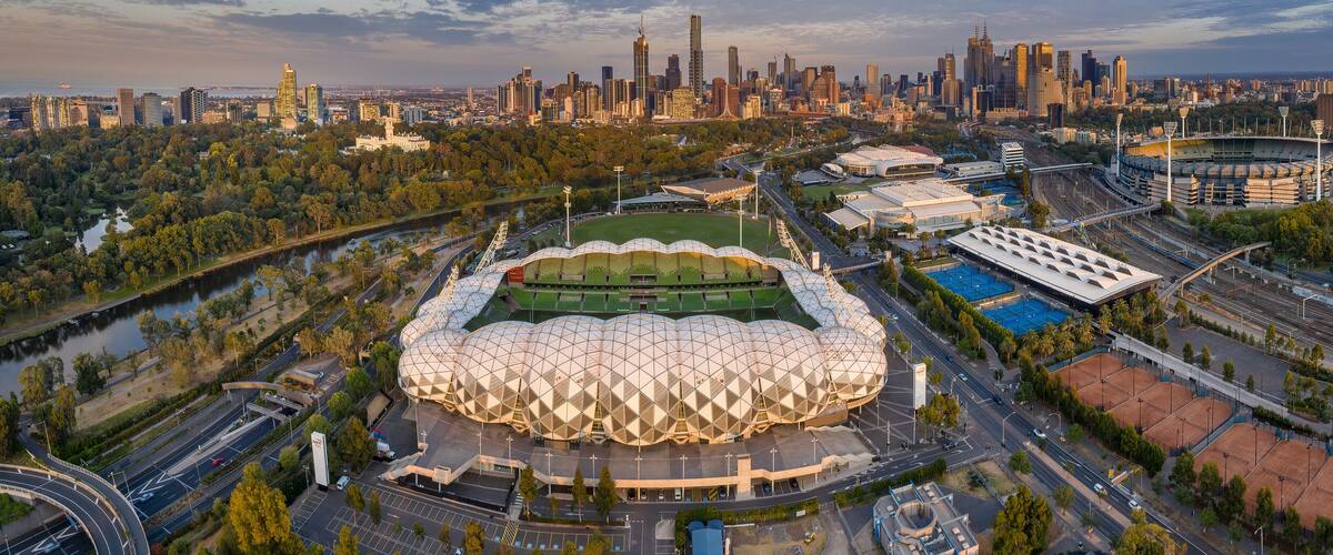 Aerial panoramic dawn view of the MCG Punt Road Oval, home of the Richmond Tigers AFL club and AAMI stadium, with the CBD in the background