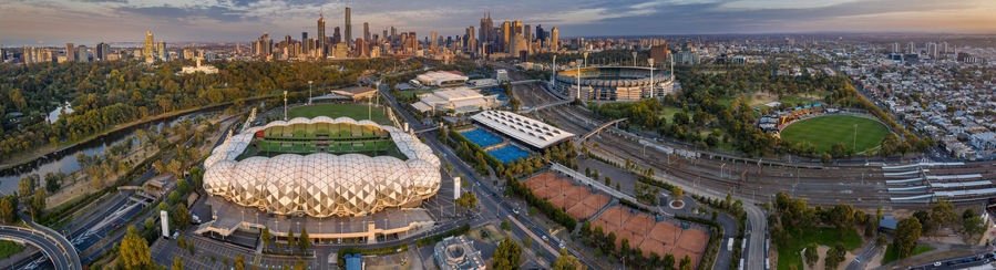 Aerial panoramic dawn view of the MCG Punt Road Oval, home of the Richmond Tigers AFL club and AAMI stadium, with the CBD in the background