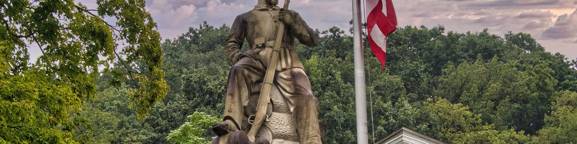 Statue of a civil war Union soldier with rifle in hand seated on a stack of logs in Pomeroy Ohio near the Meigs county Courthouse