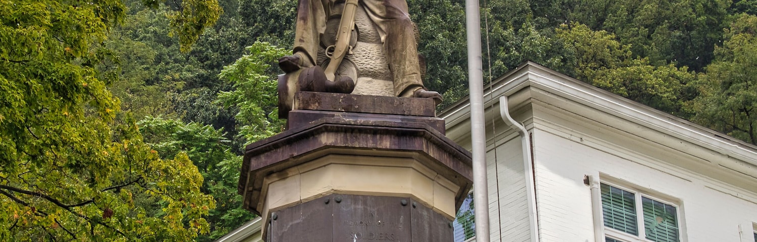 Statue of a civil war Union soldier with rifle in hand seated on a stack of logs in Pomeroy Ohio near the Meigs county Courthouse