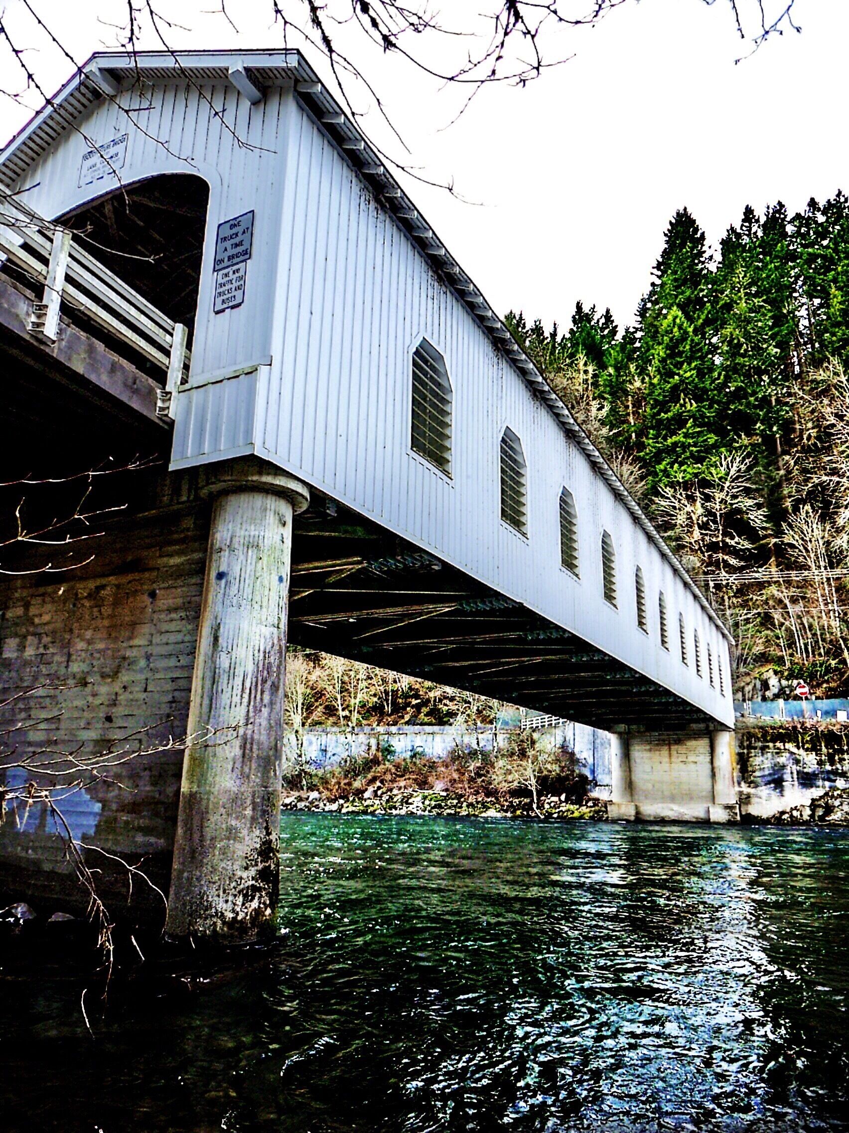Oregon has more covered bridges than any other western state, a point of pride for The Covered Bridge Society of Oregon.

However, a century or so ago, the State went absolutely bananas for the things, building six hundred of them between 1905 and 1925.  Now, let's face it, there is enough water in the state to support six hundred thousand covered bridges.  But when you hear a number like that, you can only imagine a long chain of unfortunate buggy drivers and early adopters of the newfangled horseless carriage, all forced to slalom down the entire length of a river, crossing one covered bridge after another.

Today, the number of these structures still in place is a considerably smaller and less eyebrow-twisting total of fifty-one.

The bridge you see here is the longest of all of them, at a full one hundred sixty-five feet across. Built for the then whopping sum of thirteen thousand dollars and change, it fell into disrepair until the county coughed up the less than quaint sum of seven hundred fifty thousand dollars to set things aright.  It was re-dedicated in 1987, and has been serving the good people of Lane County (and any photographer who lays eyes on it) ever since.

http://www.covered-bridges.org/bridges.htm