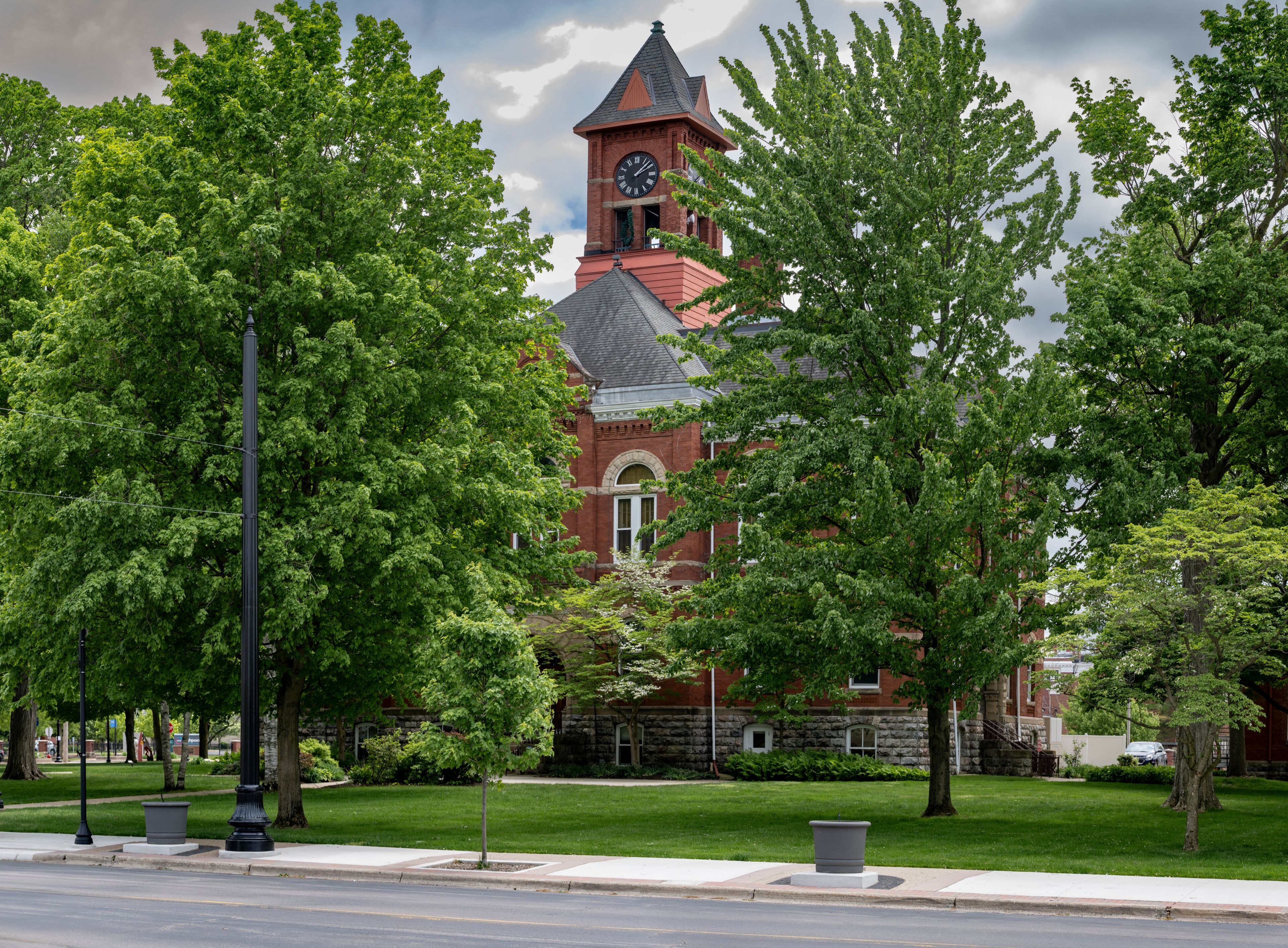 Barry County Courthouse in Hastings, Michigan with green trees and blue sky