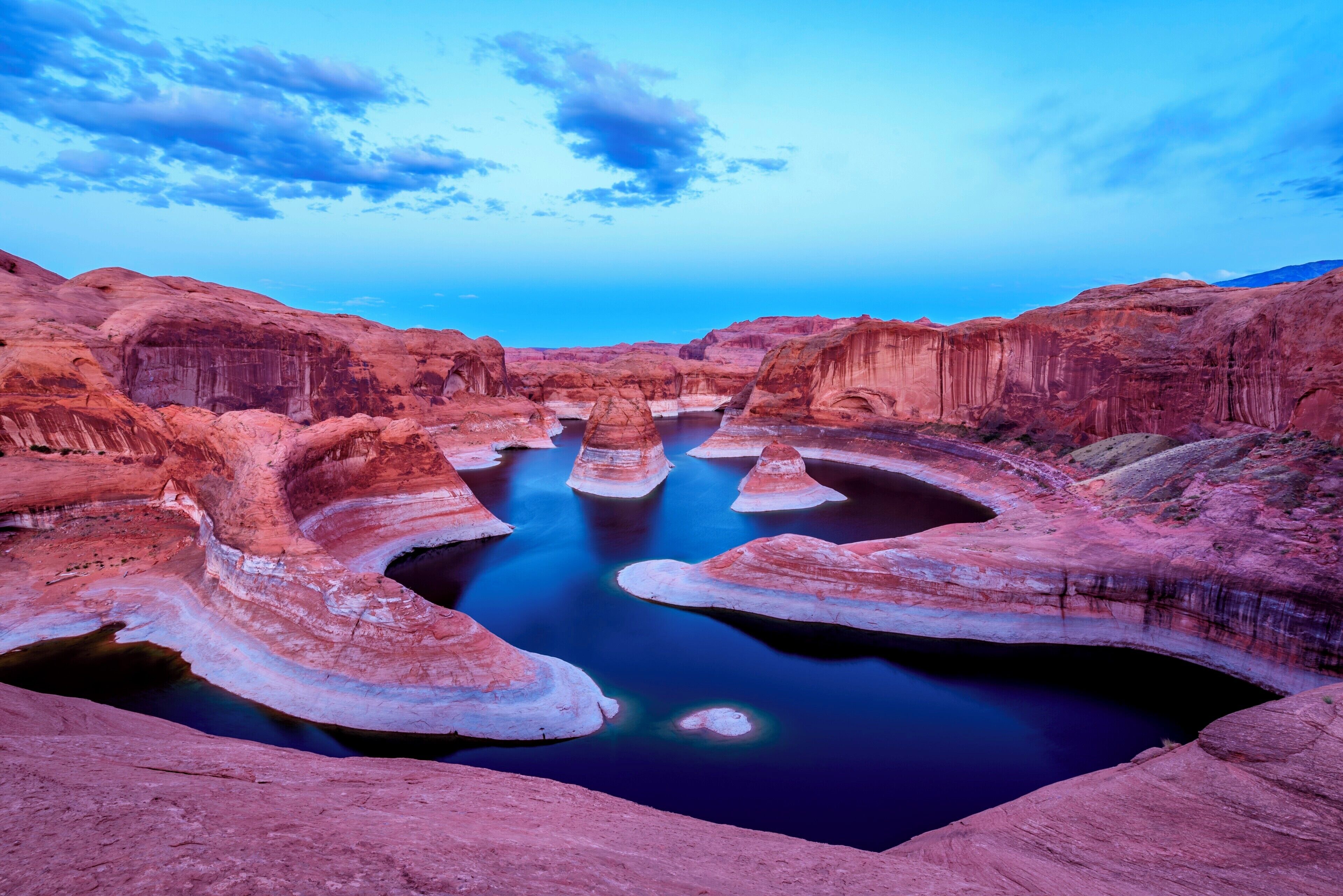 Sunset at Reflection Canyon.

It is a 2 hour drive from Escalante on a dirt road where a AWD is highly recommended. However when we arrived at the parking lot area we couldn&#x27;t believe that a Honda Fit would make it there, but there it was. :-)

From the parking lot area it is a 5 hour hike (plus minus one hour, depends on your navigation skills) through the stony desert of southern Utah. The hike itself is already beautiful but the reward when you eventually arrive at Reflection Canyon is priceless. 
We were the only two persons out there and we didn&#x27;t even meet someone on our way back the next day.

Make sure you carry enough water as there is absolutely no water source anywhere. Also I think that this place can not be found without a GPS but I was wrong with the Honda Fit before, too. ;-)

#bvsblue #GreatOutdoors
#Nature