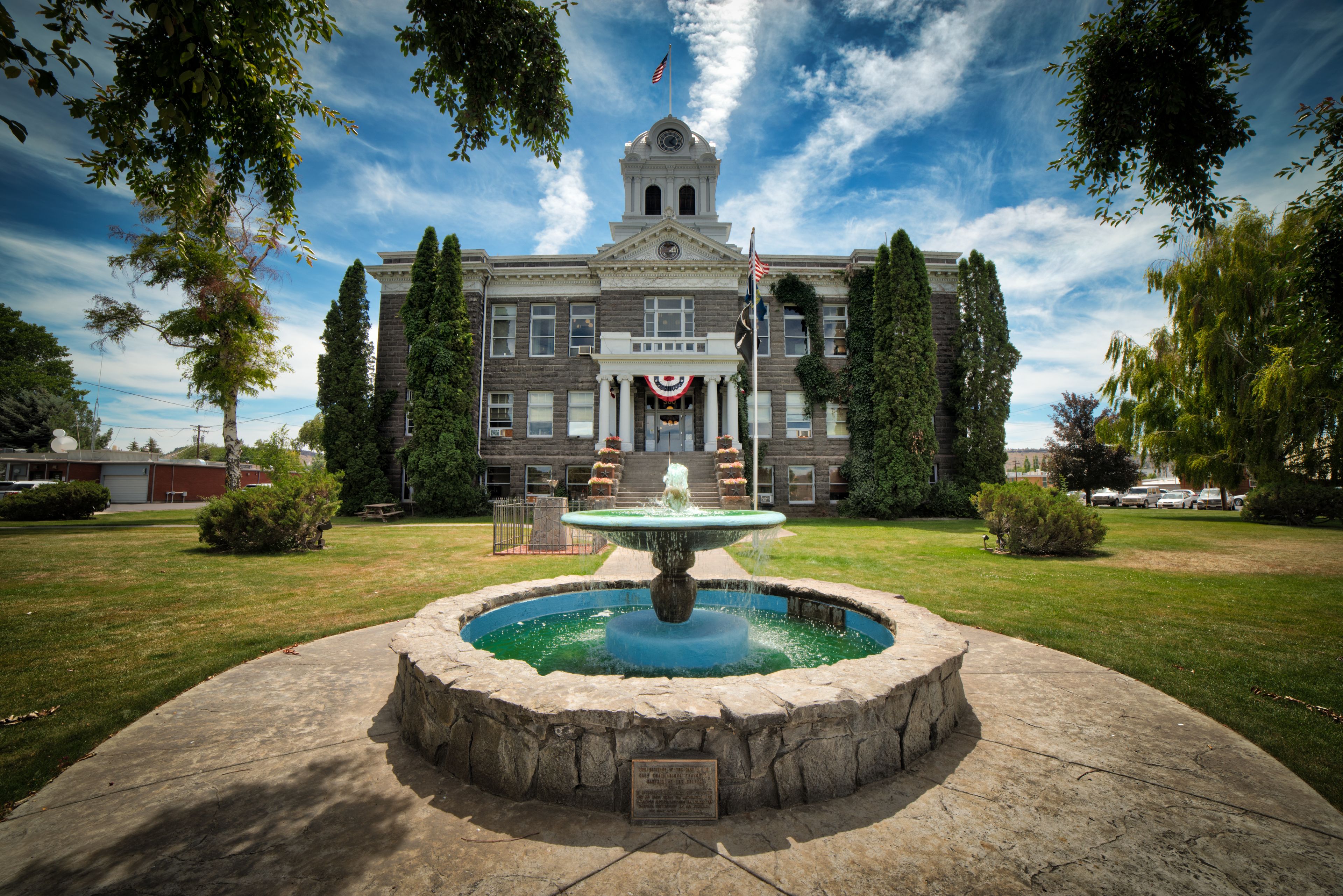 A historic building with a fountain in front.