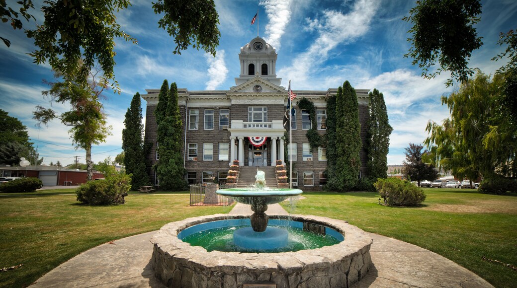 A historic building with a fountain in front.
