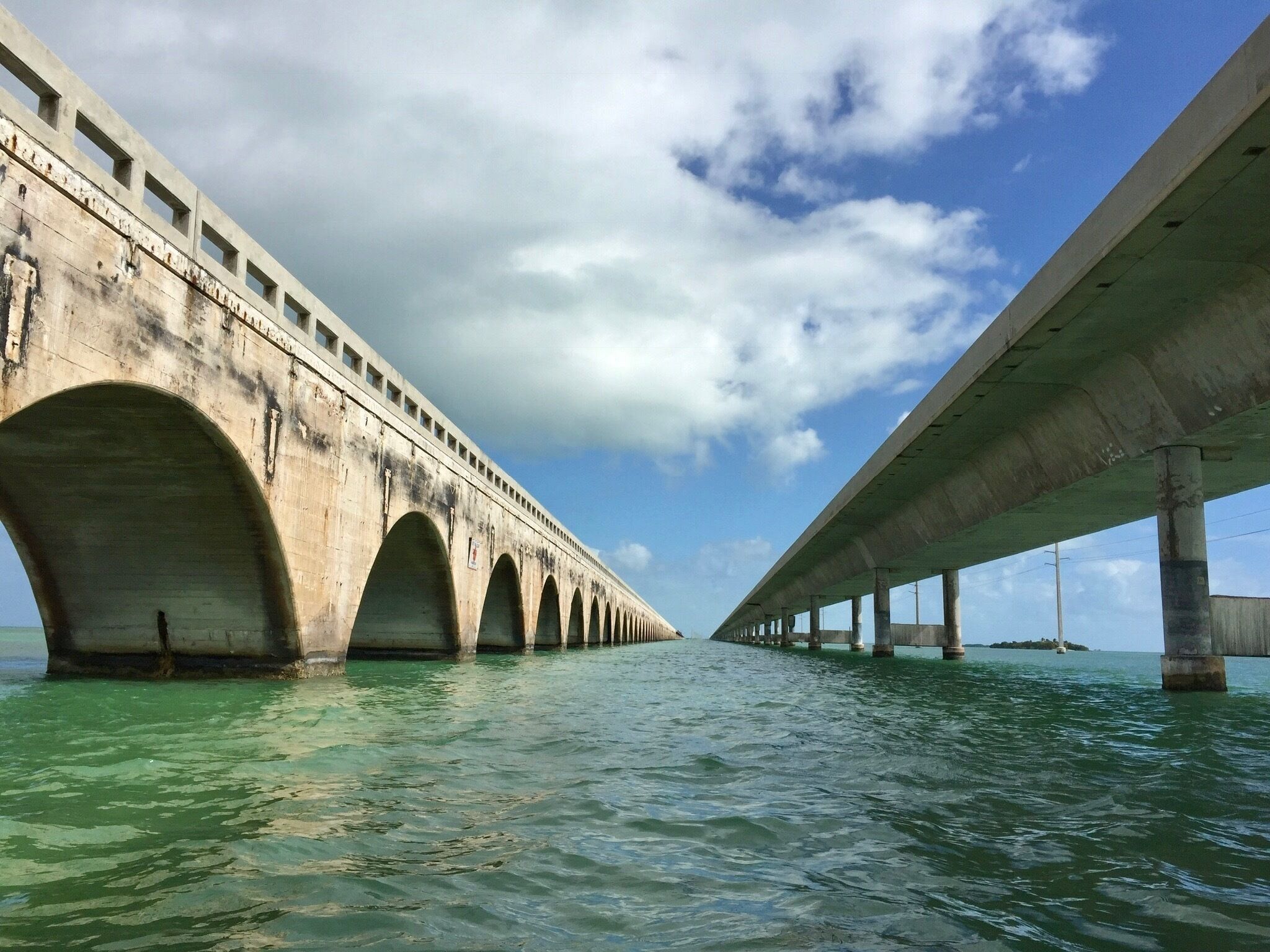 Old versus the new. The Seven mile bridge between Marathon and Key West is beautiful as you journey through the keys. On the water, you get a great view looking up. Old on the left. 