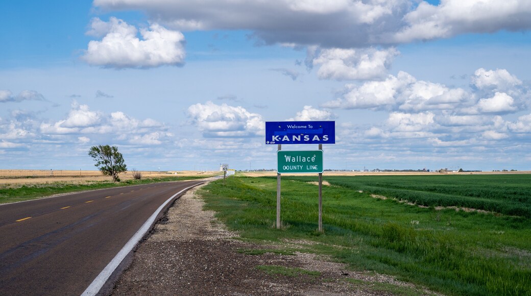 Welcome to Kansas sign on a partly cloudy spring day