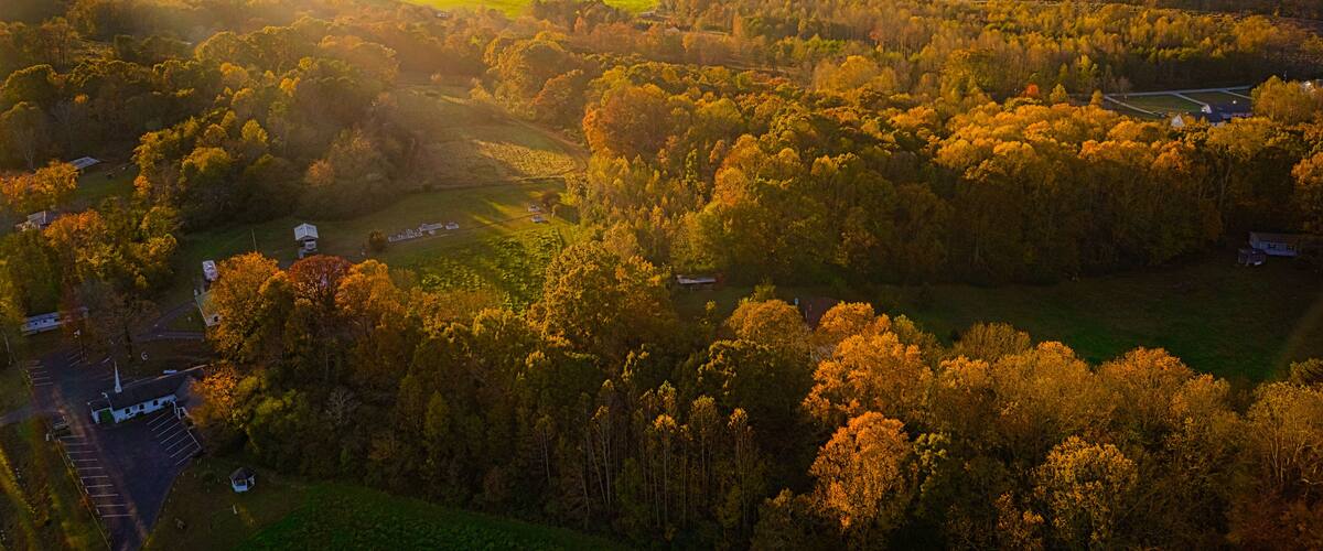 Aerial view of golden hour sunset in Georgia Mountains with sun rays