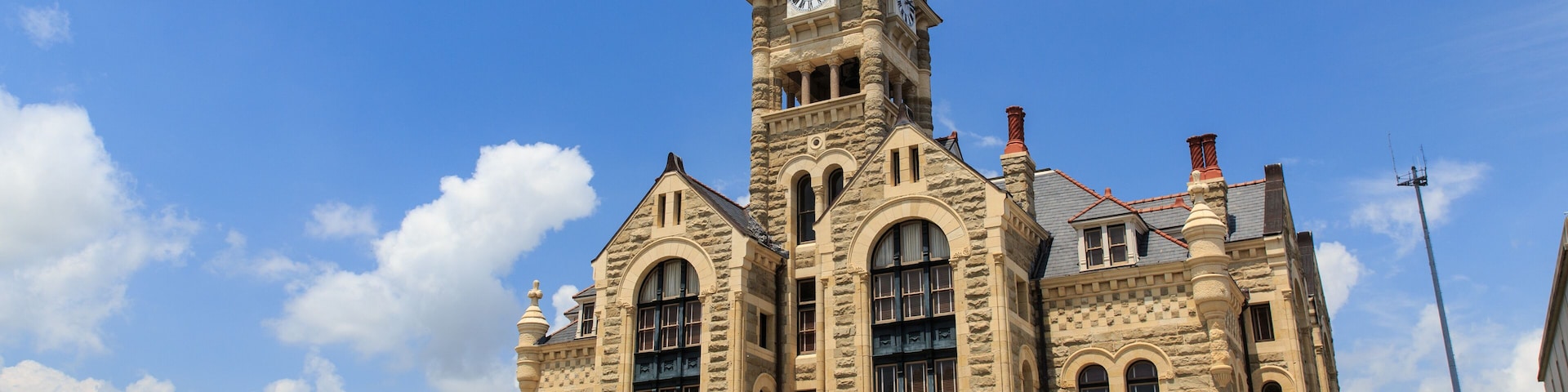 The Historical old Victoria County Courthouse built in 1892 looks like a castle. It stands next to De Leon Plaza on the main square in Victoria, Texas.