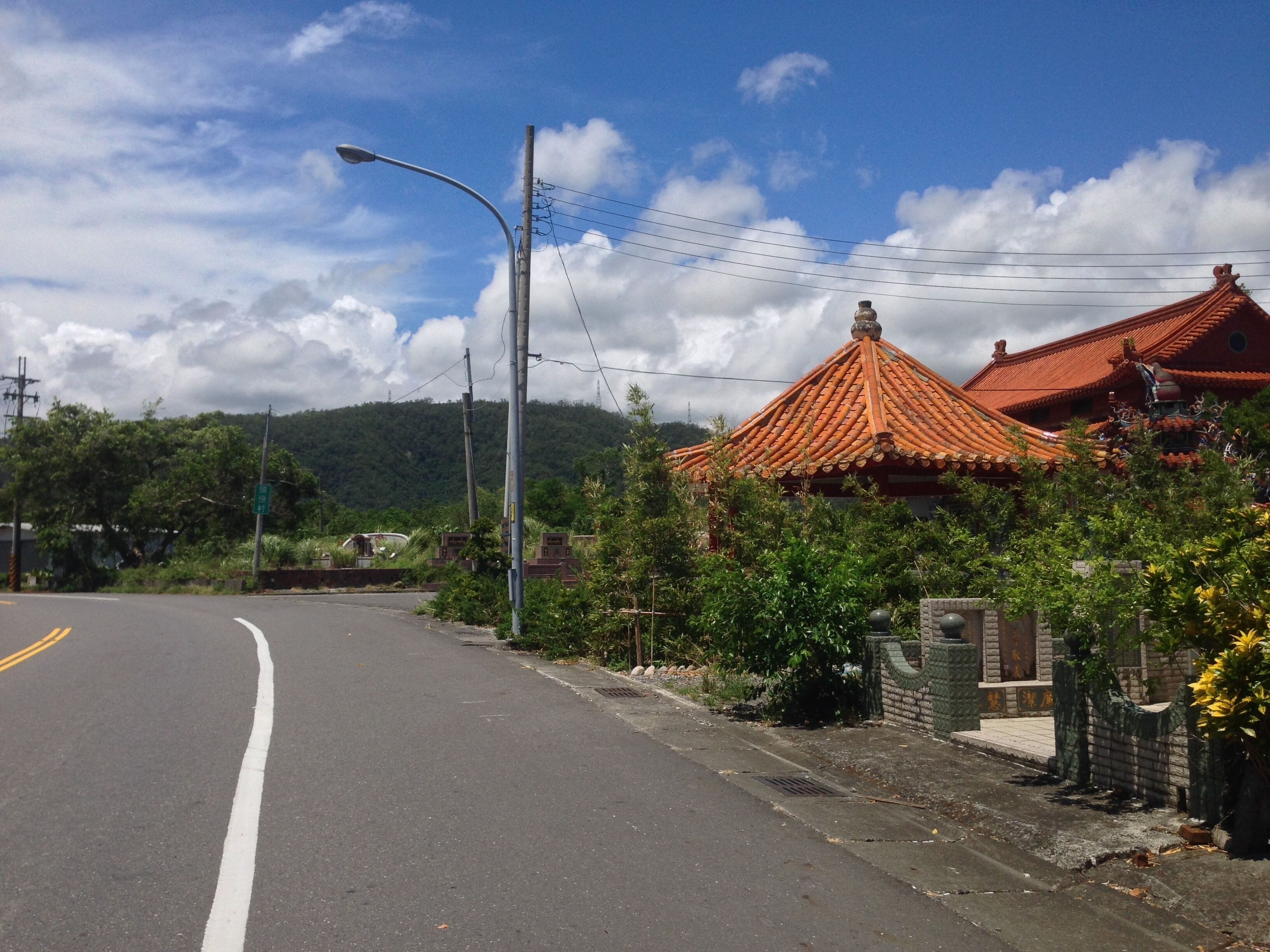 A road with a traditional building with a tiled roof.