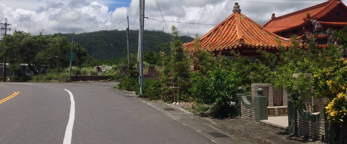 A road with a traditional building with a tiled roof.