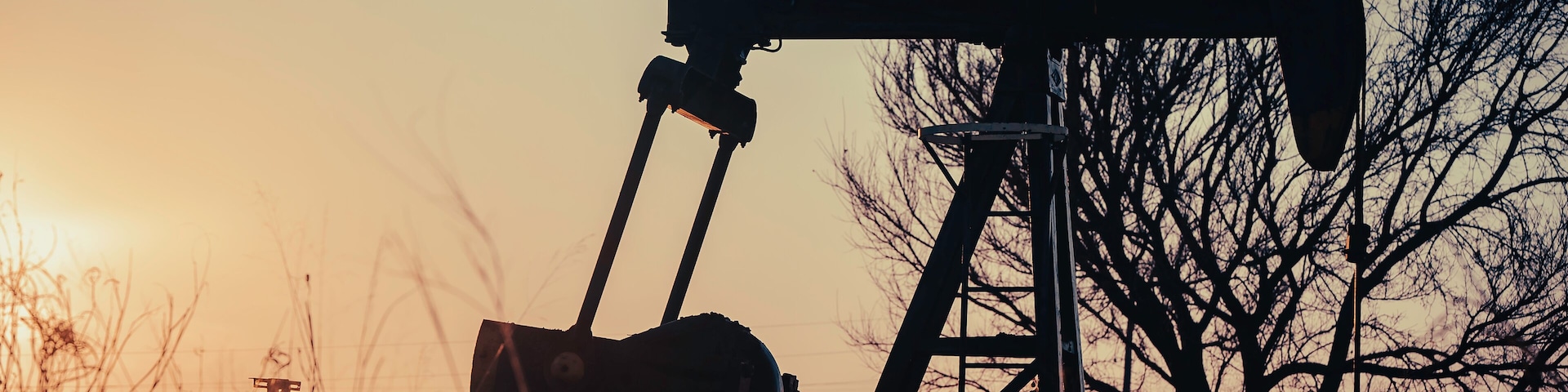 An oil pump jack in rural Texas at sunset outside of Montague County.