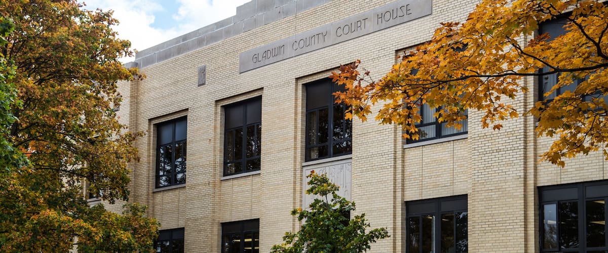A brick building labeled "Gladwin County Court House" with a staircase leading up to the entrance.