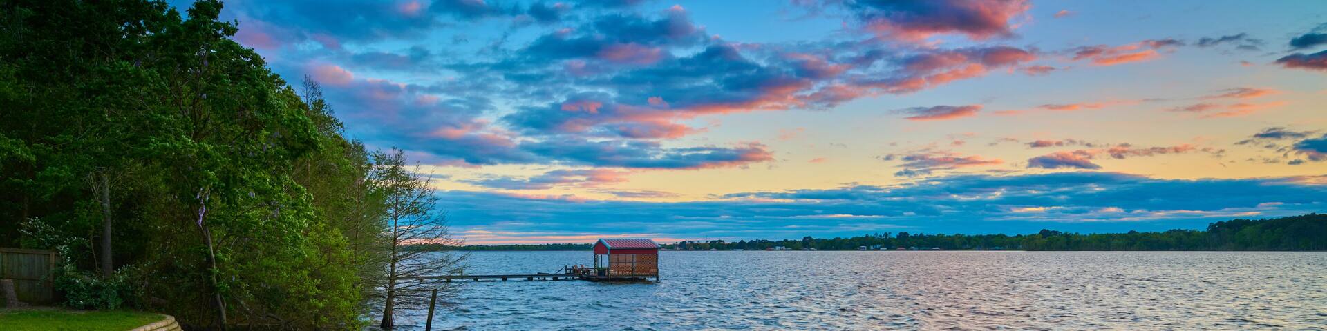 Boathouse on Lake Tyler, Texas with colorful clouds.