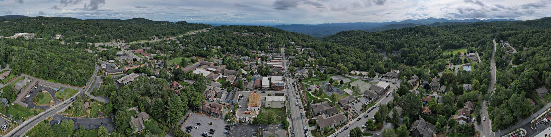 A town surrounded by mountains and dense forests.