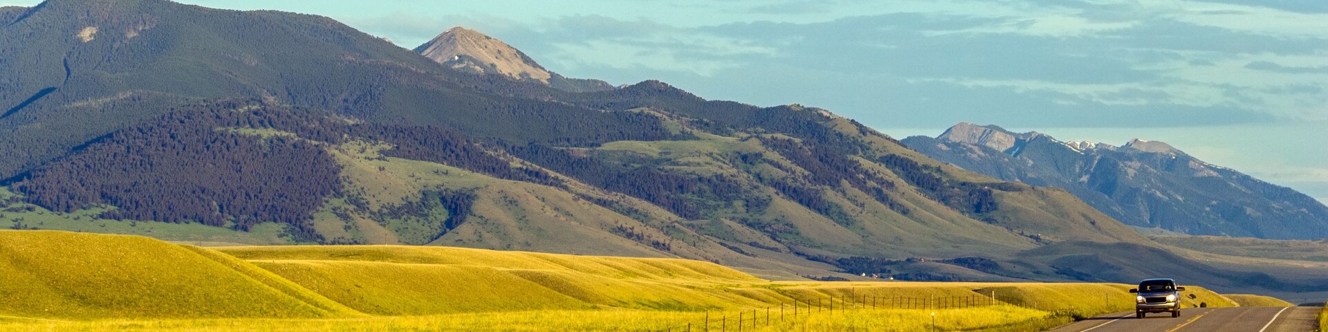 Local road through the meadows of sunny Montana landscape, USA