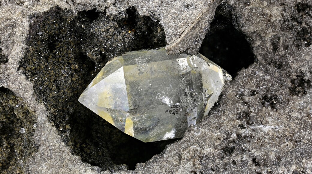 Herkimer diamond nestled in bedrock isolated on white background