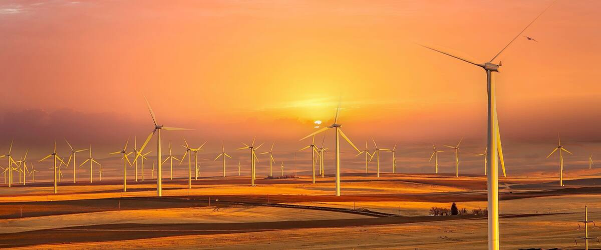 Wind generators in Sherman County Oregon wheat country are shown against a blue sky. Located a few miles south of the Columbia River Gorge.