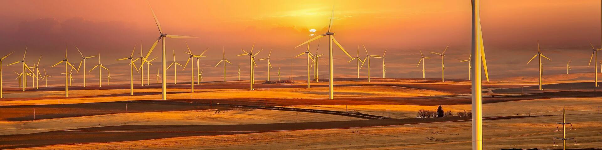 Wind generators in Sherman County Oregon wheat country are shown against a blue sky. Located a few miles south of the Columbia River Gorge.