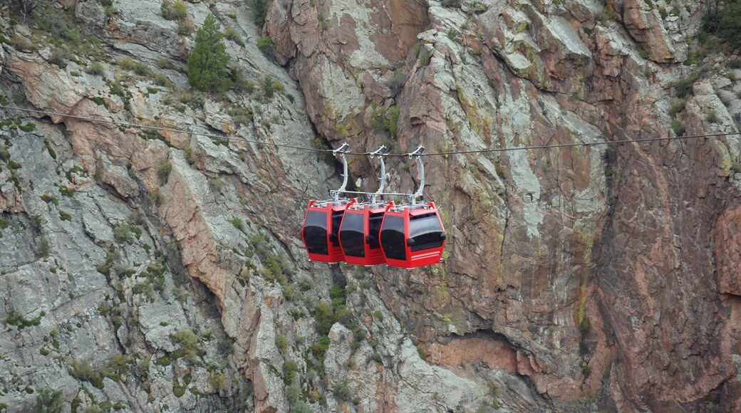 Red gondolas suspended over the Arkansas River at the Royal Gorge Bridge & Park in Fremont County, Colorado.