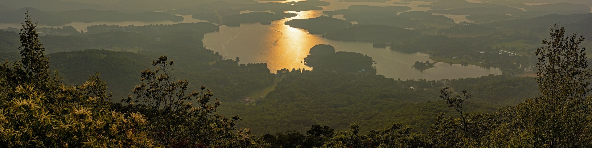 A river winding through a valley with surrounding hills and dense vegetation.
