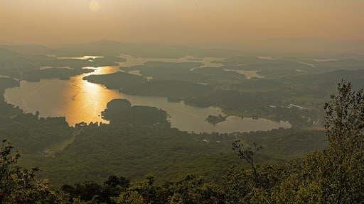 A river winding through a valley with surrounding hills and dense vegetation.