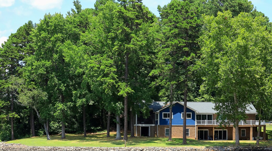 Beautiful lakefront home surrounded by tall trees in North Carolina, USA.