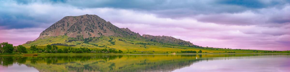 Bear Butte, or Paha Sapa in Lakota language for Black Hills, reflected on the Bear Butte Lake in Sturgis, South Dakota, United States: Black Hills Country Summer Landscape