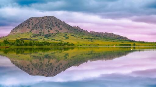 Bear Butte, or Paha Sapa in Lakota language for Black Hills, reflected on the Bear Butte Lake in Sturgis, South Dakota, United States: Black Hills Country Summer Landscape