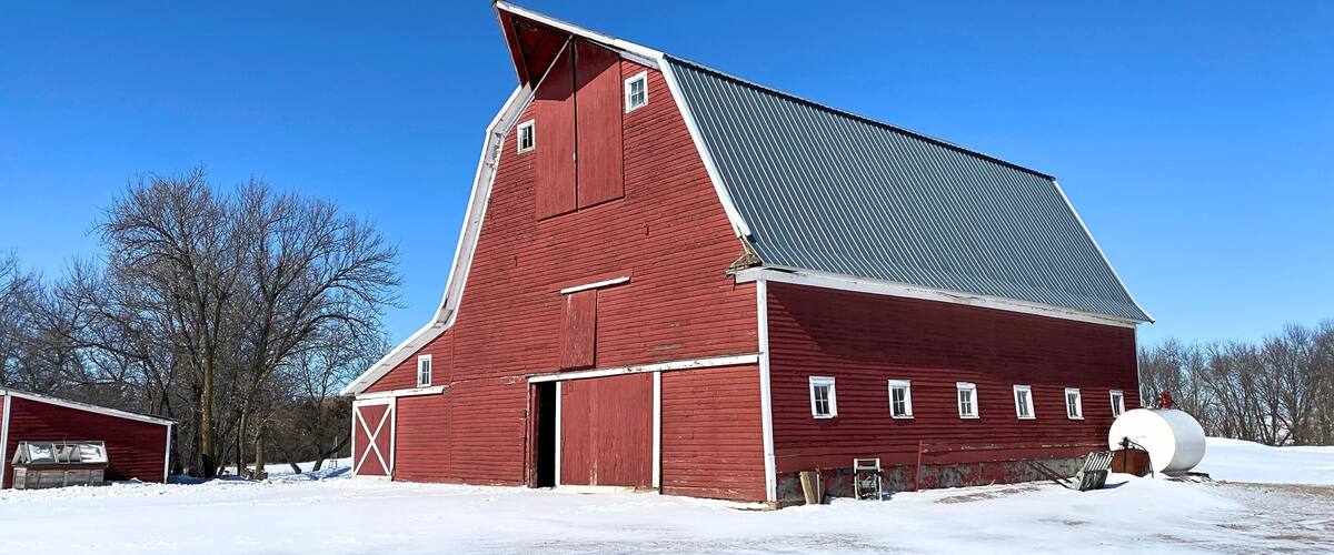 Almost a perfect red wood barn in the snow scene
