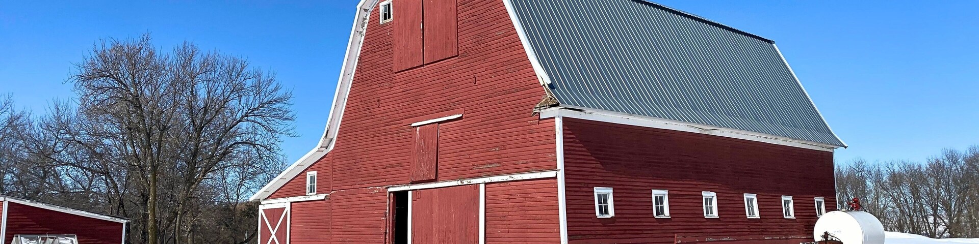 Almost a perfect red wood barn in the snow scene