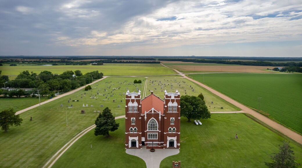 Aerial view of Salemsborg Lutheran Church in a green field near a cemetery in Saline County, Kansas
