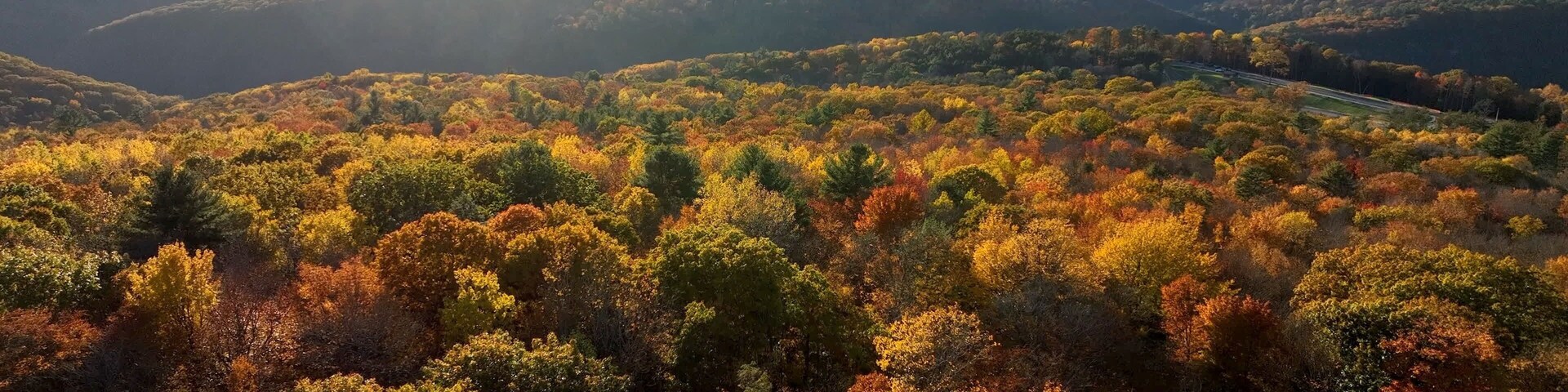 Sunset over mountains, forest and trees in Fall Autumn colors near Pennsylvania Grand Canyon