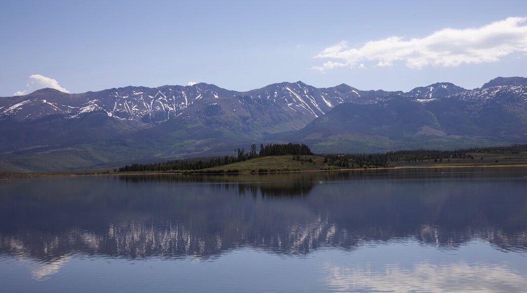 Mountains reflect in clear waters of scenic Meadow Creek Reservoir in Colorado, United States