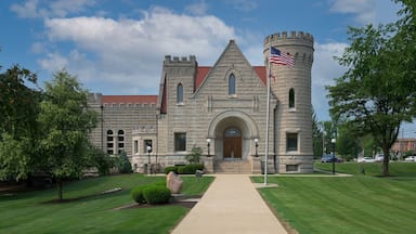 A historic stone building with a tower and a flag.
